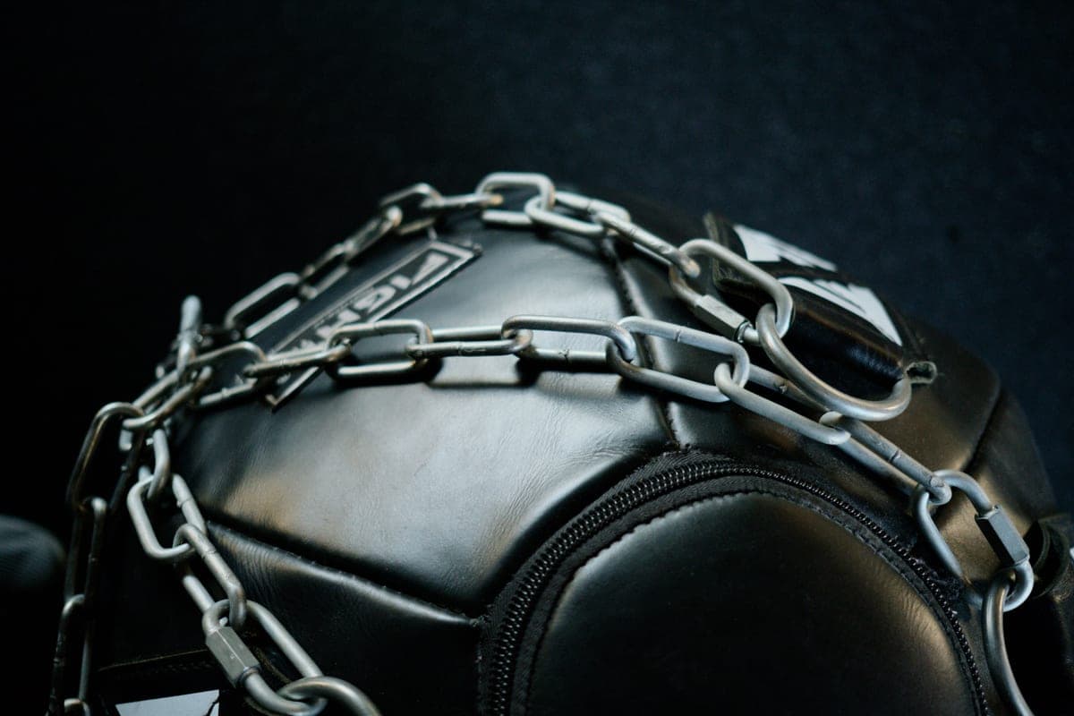 Close-up of gym equipment wrapped in heavy metal chain