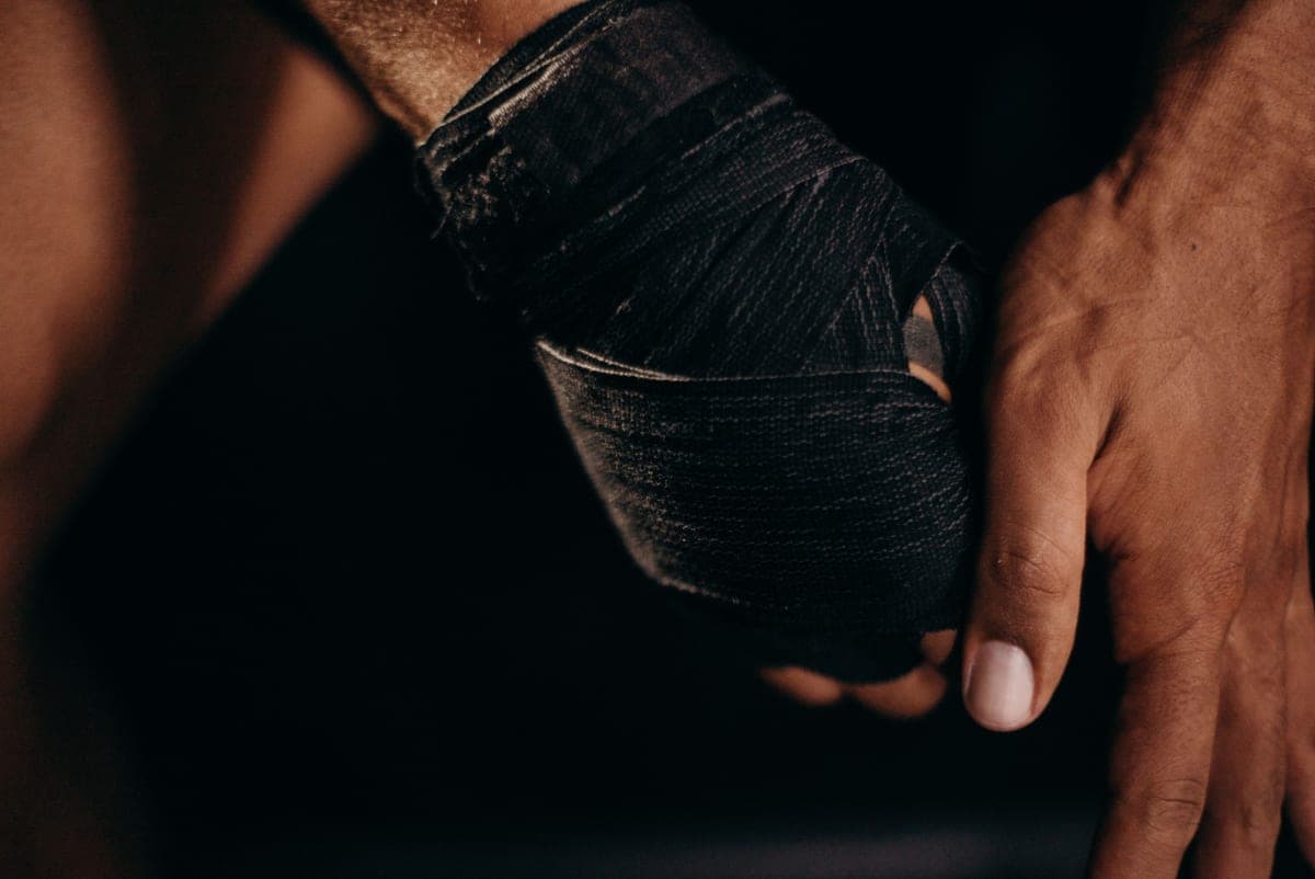Close-up of a hand wrapped in black boxing hand wraps